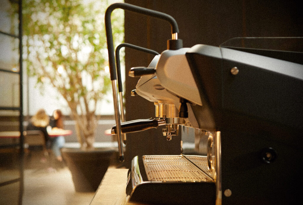 The image shows a Faema E71E espresso machine in a warm light.